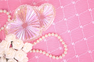 strand of pearls on pink background 
